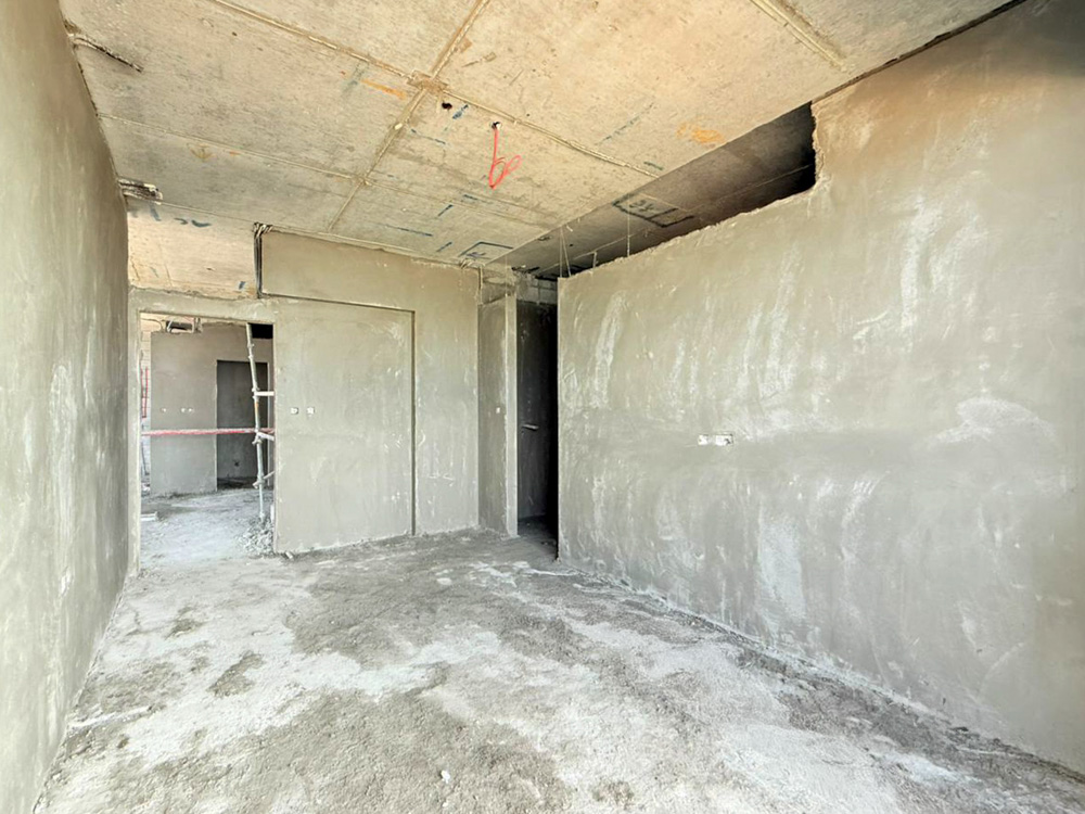 Beach Walk Iii By Imtiaz An unfinished interior space with bare walls, dusty floors, and visible construction materials and tools.